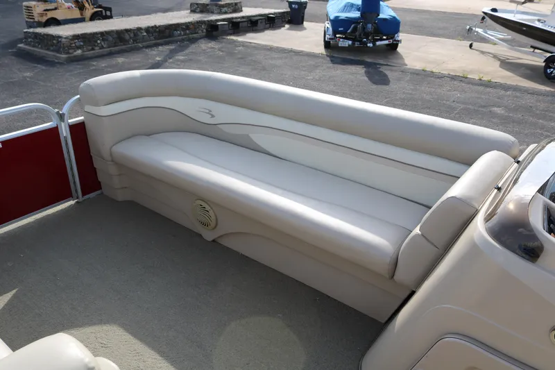 Slide: The Image of 2013 Bennington 22 SLX pontoon boat with beige seating and spacious interior. - 13