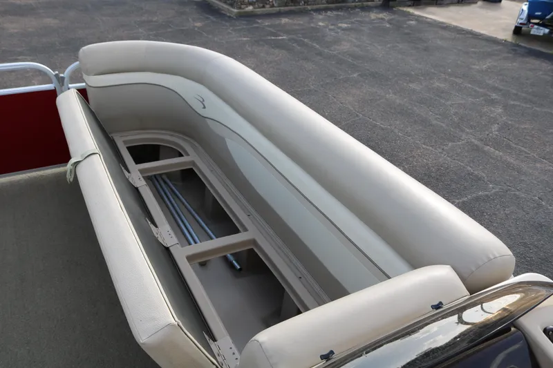 Slide: The Image of 2013 Bennington 22 SLX boat seat with storage compartment, beige upholstery, and open hatch. - 14