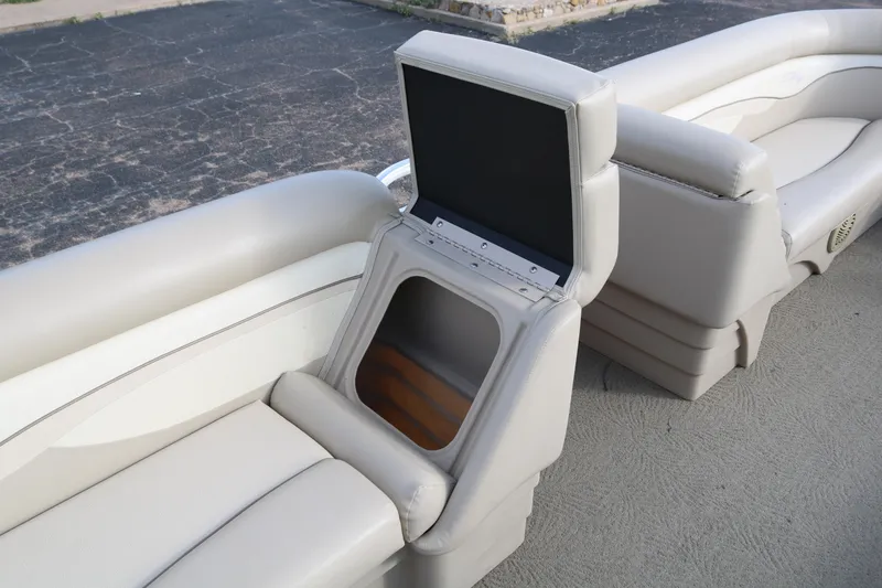 Slide: The Image of 2013 Bennington 22 SLX boat interior with open storage compartment and cushioned seating. - 18