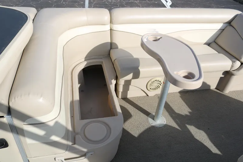 Slide: The Image of 2013 Bennington 22 SLX boat interior with beige seating and cupholder table. - 20