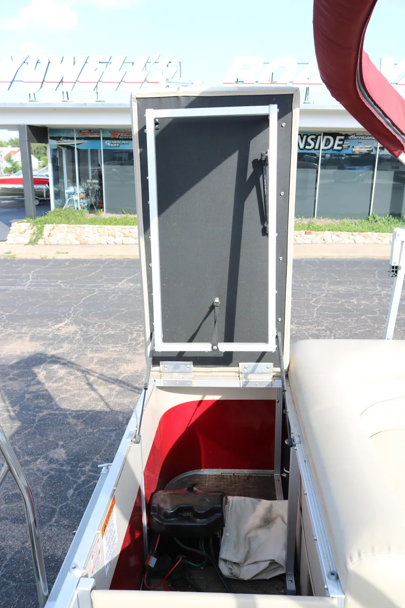 Slide: The Image of Open storage compartment on a 2013 Bennington 22 SLX boat, showing interior details. - 22