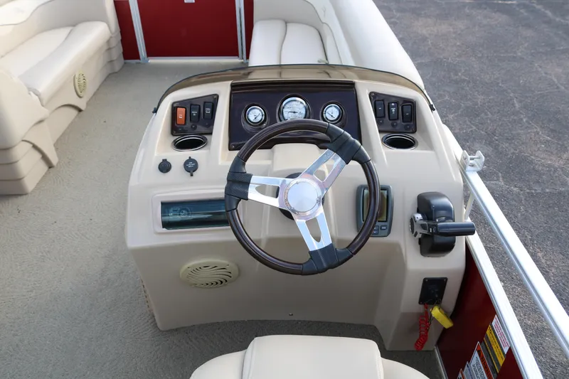 Slide: The Image of 2013 Bennington 22 SLX boat dashboard with steering wheel and control panel. - 23