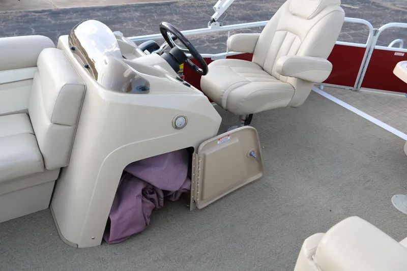 Slide: The Image of 2013 Bennington 22 SLX boat interior with beige seating and steering console. - 25