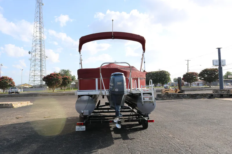 Slide: The Image of 2013 Bennington 22 SLX pontoon boat with Yamaha 90 engine, parked outdoors. - 29