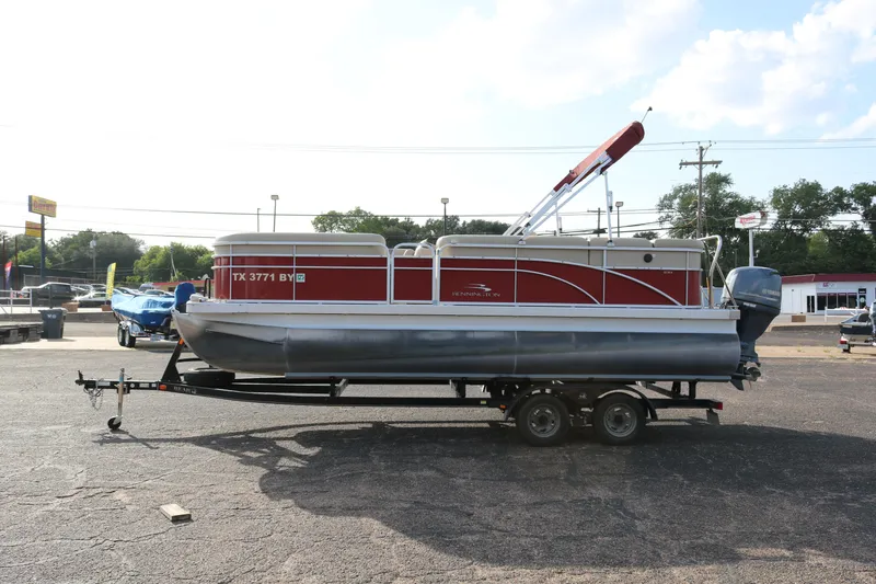 Slide: The Image of 2013 Bennington 22 SLX pontoon boat on trailer in parking lot. - 4