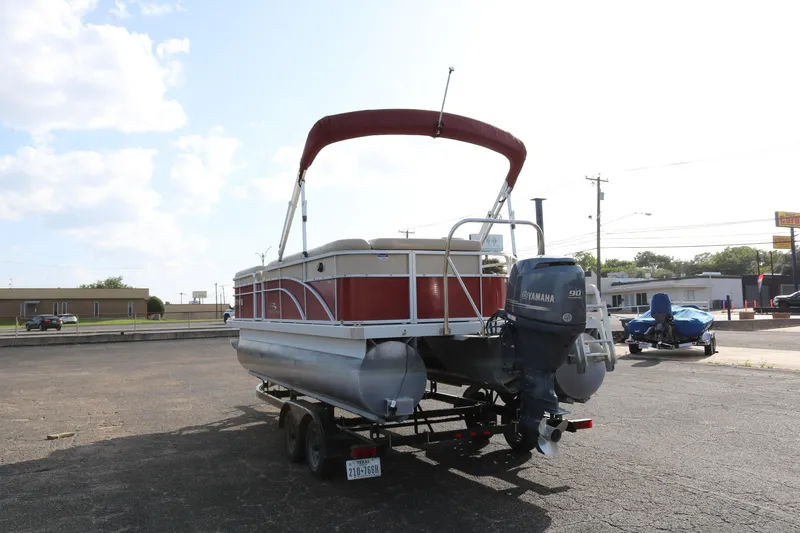 Slide: The Image of 2013 Bennington 22 SLX pontoon boat with Yamaha motor on trailer, parked outdoors. - 5