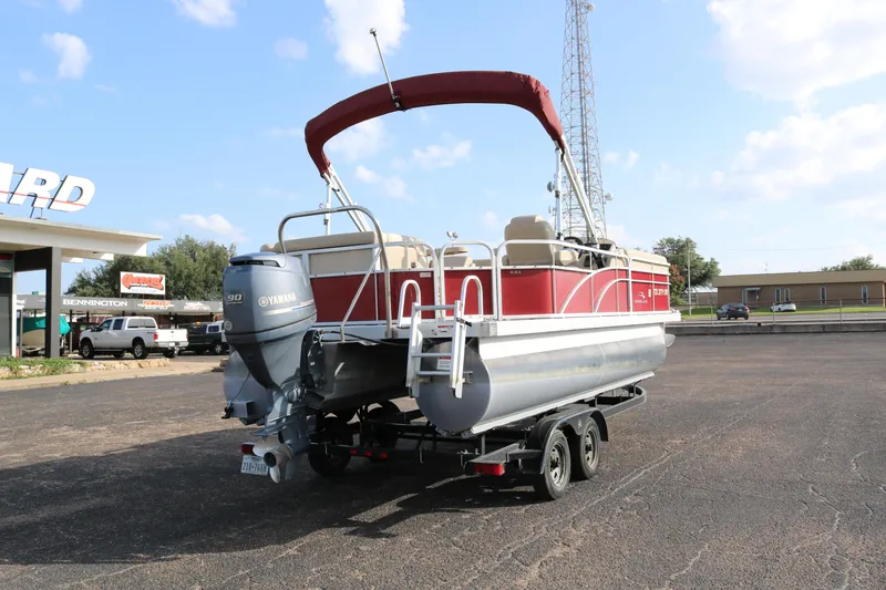 Slide: The Image of 2013 Bennington 22 SLX pontoon boat with Yamaha motor on trailer, parked outdoors. - 6