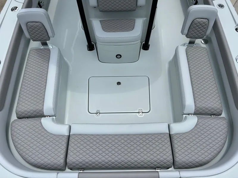 Slide: The Image of 2026 Caymas 28 HB boat interior with quilted seating and storage compartments. - 10