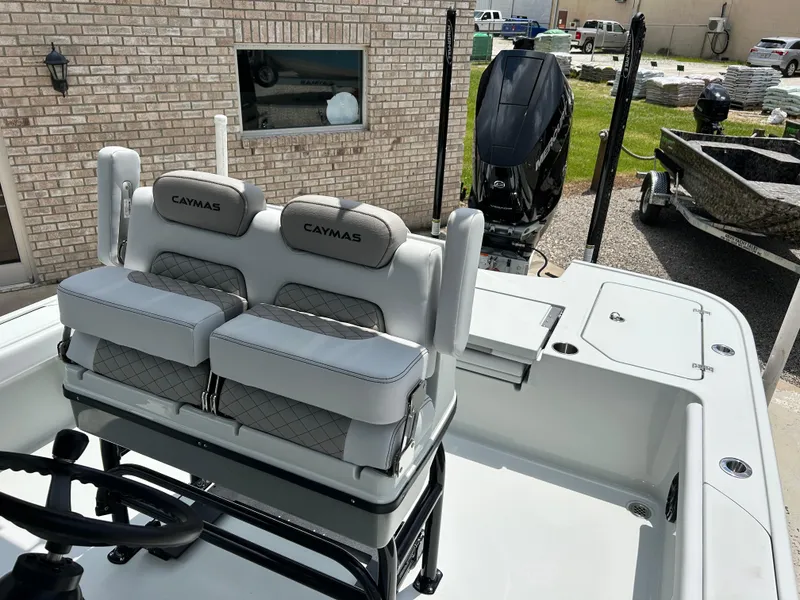 Slide: The Image of 2026 Caymas 28 HB boat interior with cushioned seating and modern design. - 13