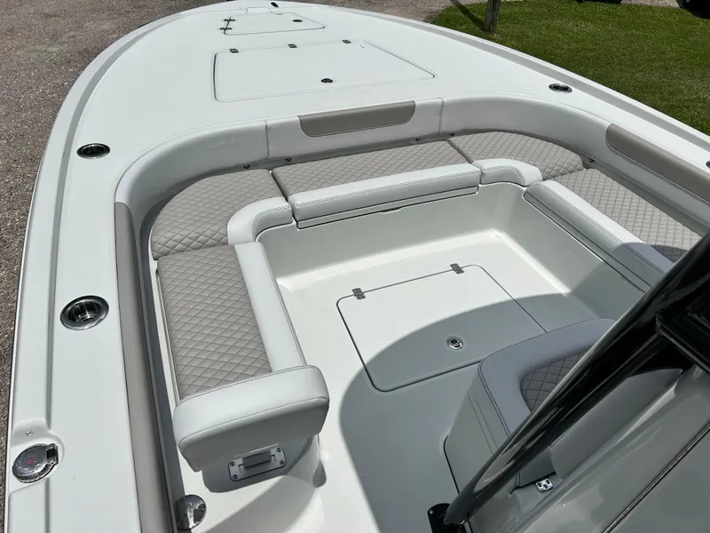 Slide: The Image of 2026 Caymas 28 HB boat interior with cushioned seating and storage compartments. - 14