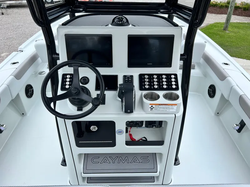 Slide: The Image of 2026 Caymas 28 HB boat dashboard with dual screens and steering wheel. - 21