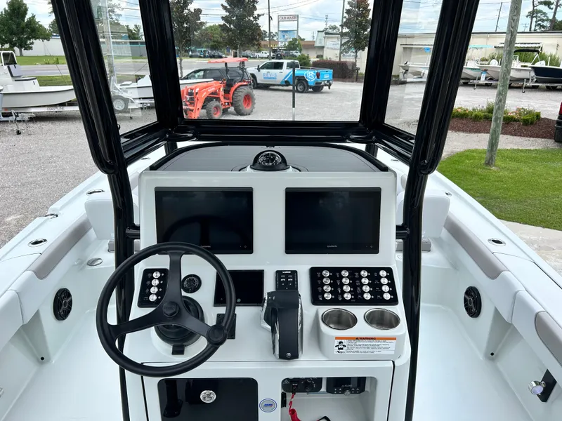 Slide: The Image of 2026 Caymas 28 HB boat dashboard with steering wheel, dual screens, and control panel. - 22