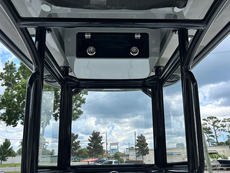 Slide: The Image of 2026 Caymas 28 HB boat interior with glass enclosure and overhead storage. - 23