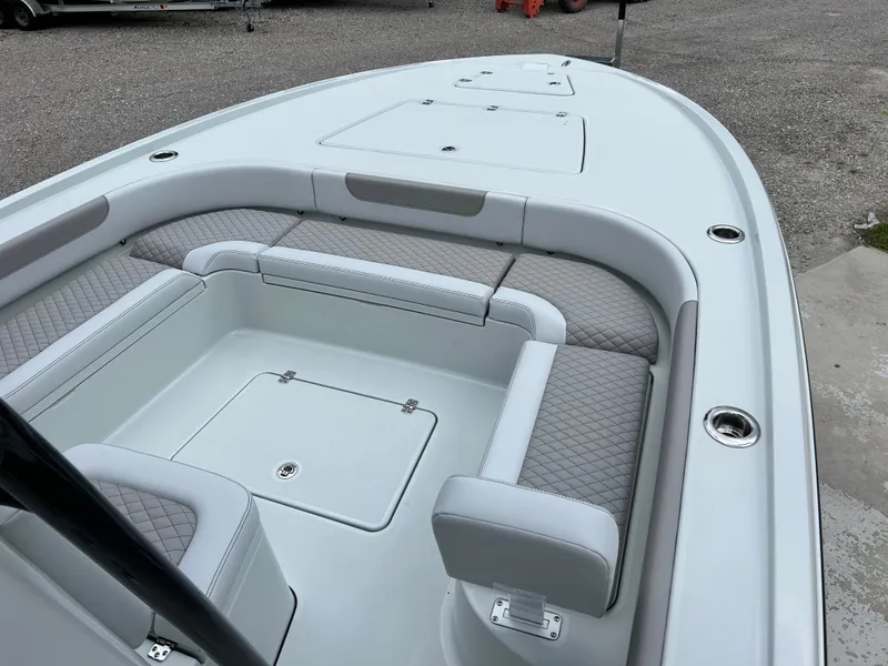 Slide: The Image of 2026 Caymas 28 HB boat interior with cushioned seating and storage compartments. - 25