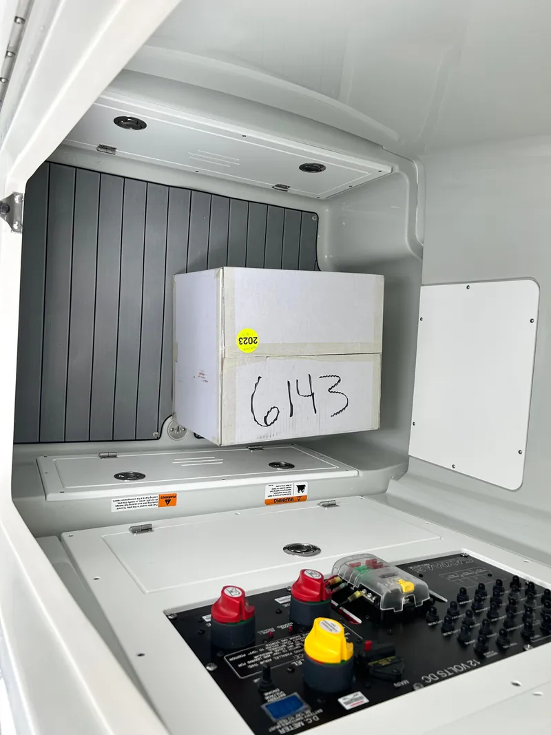 Slide: The Image of Electrical panel and storage compartment in 2026 Caymas 28 HB boat. - 26