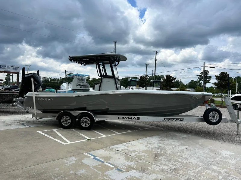 Slide: The Image of 2026 Caymas 28 HB boat on trailer under cloudy sky in parking lot. - 6