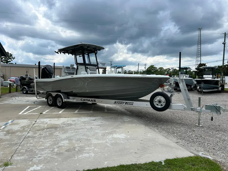 Slide: The Image of 2026 Caymas 28 HB boat on trailer under cloudy sky. - 7
