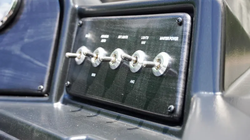 Slide: The Image of Control panel of 2025 G3 Angler V164 C boat with toggle switches. - 13