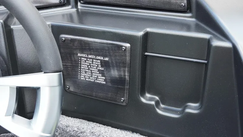 Slide: The Image of 2025 G3 Angler V164 C dashboard with boater's safety checklist plaque. - 28