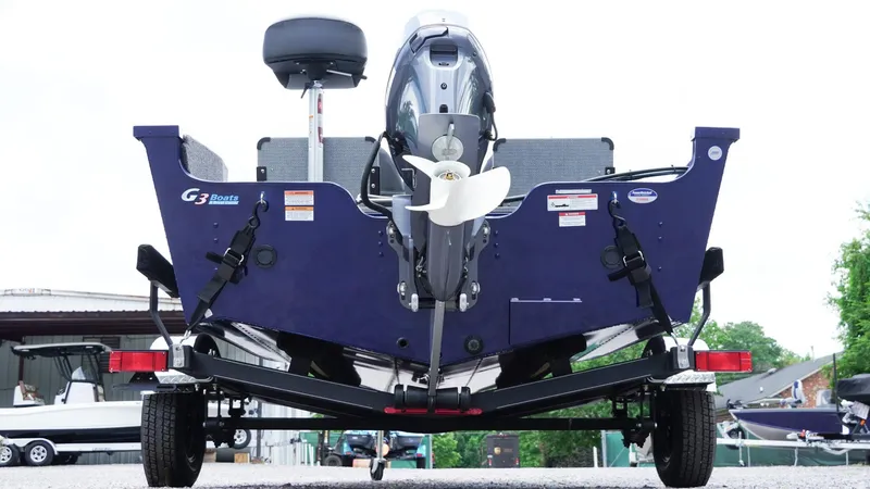 Slide: The Image of 2025 G3 Angler V164 C boat on trailer, rear view with motor and propeller visible. - 34