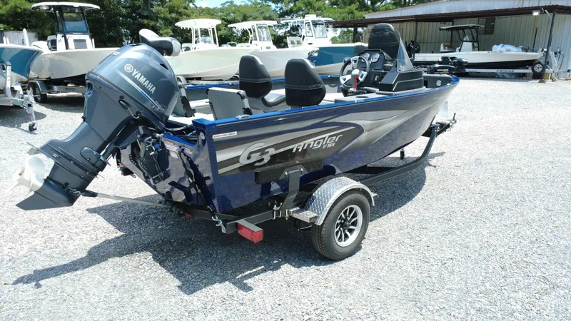 Slide: The Image of 2025 G3 Angler V164 C boat with Yamaha motor on a trailer in a gravel lot. - 5