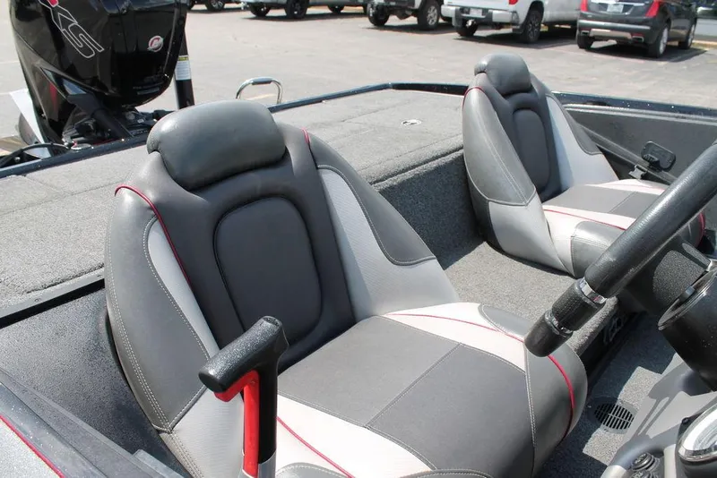 Slide: The Image of 2021 Ranger Z175 boat interior with gray and white seats, steering wheel, and motor. - 4