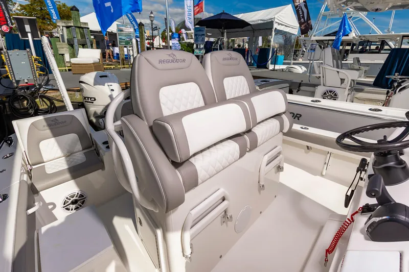 Slide: The Image of 2026 Regulator 26XO boat interior with plush seating and modern controls. - 8