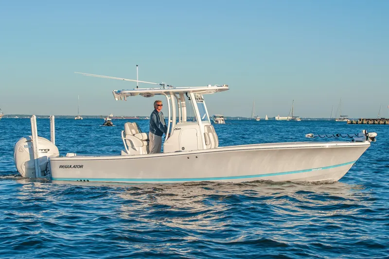 Slide: The Image of 2026 Regulator 26XO boat cruising on open water under clear blue sky. - 3