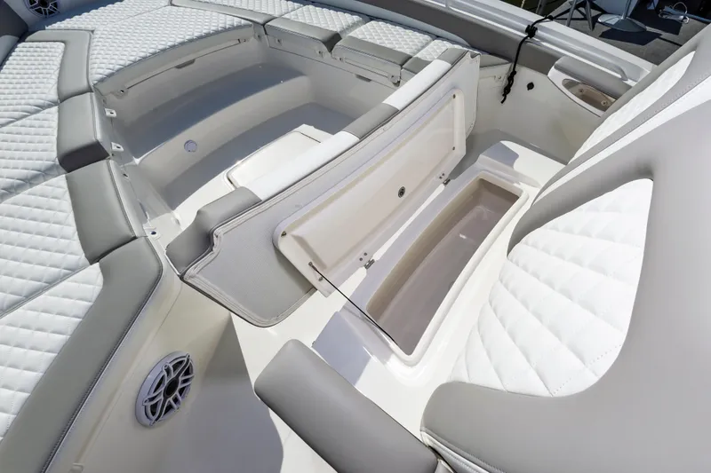 Slide: The Image of 2026 Regulator 26XO boat interior with open storage compartment and cushioned seating. - 18