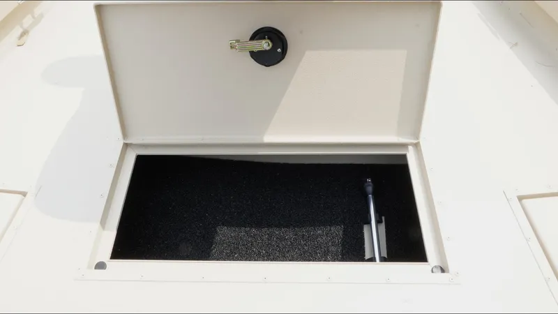 Slide: The Image of Open storage compartment on 2025 G3 Bay 19 GX boat. - 13