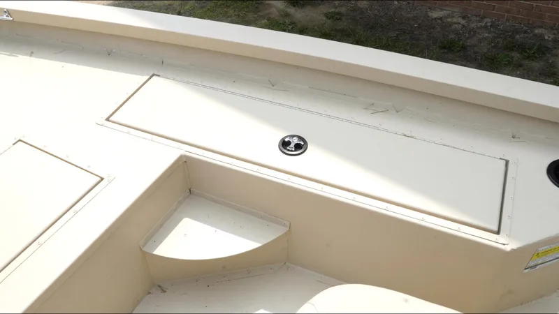 Slide: The Image of 2025 G3 Bay 19 GX boat interior with storage compartment and seating area. - 14