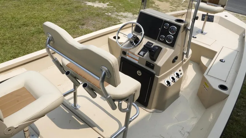 Slide: The Image of 2025 G3 Bay 19 GX boat interior with steering console and seating. - 17