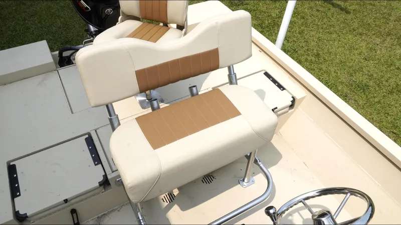 Slide: The Image of 2025 G3 Bay 19 GX boat interior with beige and brown seating. - 20