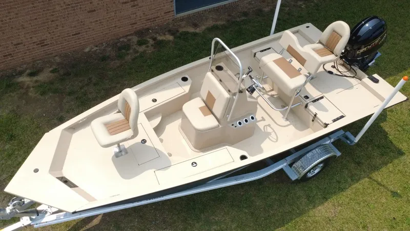 Slide: The Image of 2025 G3 Bay 19 GX boat on trailer, beige seats, outboard motor, grassy background. - 3