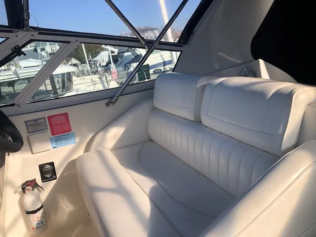 Slide: The Image of 2004 Cruisers Yachts 280 Express interior with white seating and cockpit view. - 12