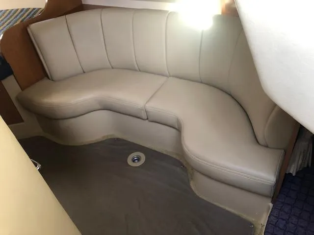 Slide: The Image of 2004 Cruisers Yachts 280 Express interior with beige leather seating. - 13