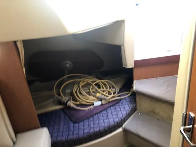 Slide: The Image of 2004 Cruisers Yachts 280 Express cabin interior with coiled rope and seating area. - 17