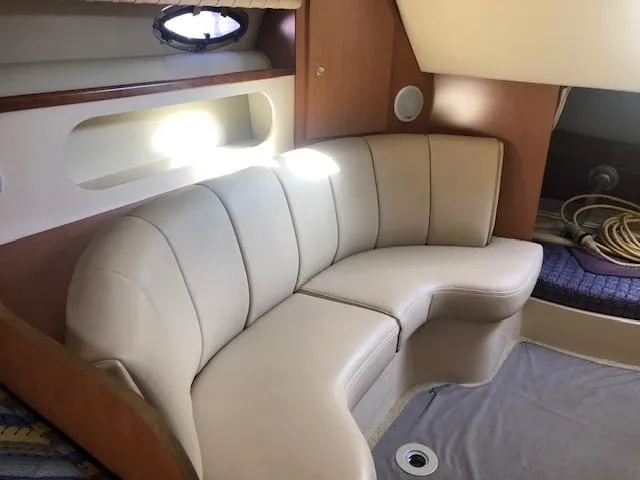 Slide: The Image of 2004 Cruisers Yachts 280 Express interior with beige leather seating and wood accents. - 18