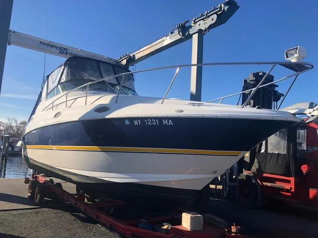 Slide: The Image of 2004 Cruisers Yachts 280 Express boat on trailer at marina. - 24