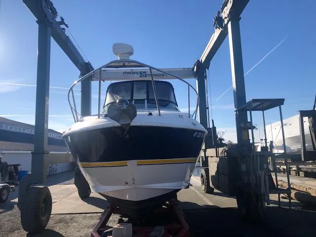 Slide: The Image of 2004 Cruisers Yachts 280 Express on a lift at a marina. - 27
