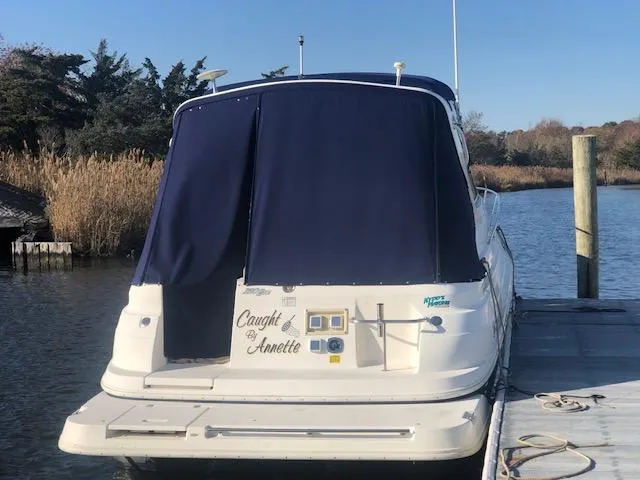 Slide: The Image of 2004 Cruisers Yachts 280 Express docked with blue cover, rear view. - 3