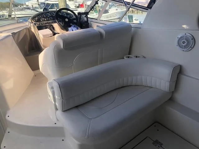 Slide: The Image of 2004 Cruisers Yachts 280 Express interior with white seating and helm. - 5