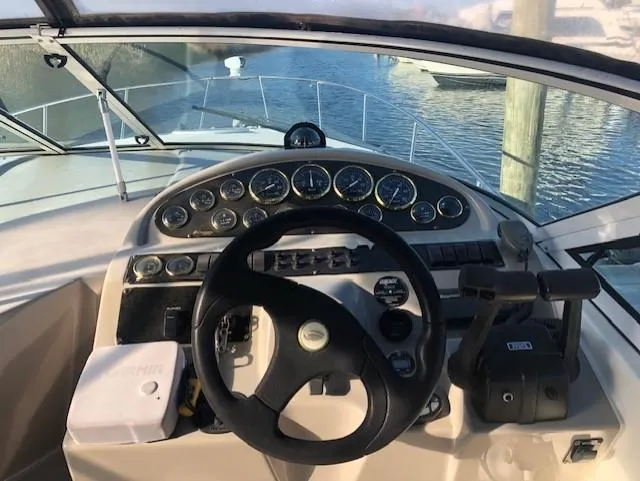 Slide: The Image of Cockpit view of 2004 Cruisers Yachts 280 Express, showcasing steering wheel and control panel. - 7