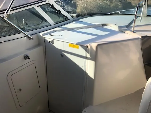 Slide: The Image of 2004 Cruisers Yachts 280 Express boat interior with helm and seating area. - 8