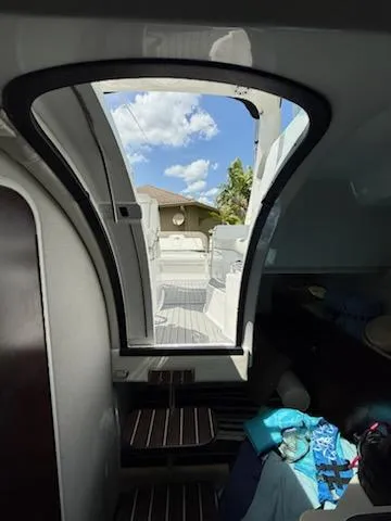 Slide: The Image of Interior view of 2019 Monterey 295 Sport Yacht with open hatch and clear sky. - 10