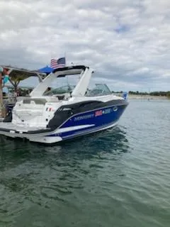 Slide: The Image of 2019 Monterey 295 Sport Yacht docked on calm water under cloudy skies. - 16