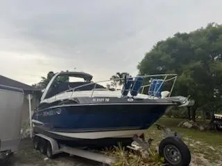 Slide: The Image of 2019 Monterey 295 Sport Yacht on trailer, parked outdoors. - 7