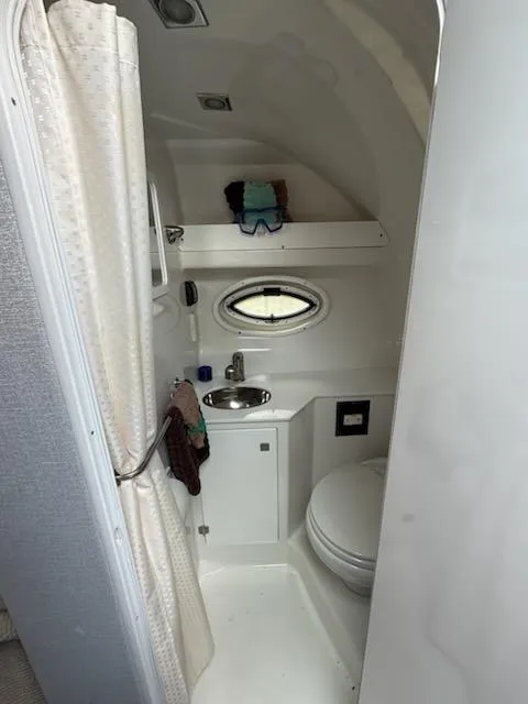 Slide: The Image of Compact bathroom in a 2019 Monterey 295 Sport Yacht with shower, sink, and toilet. - 9