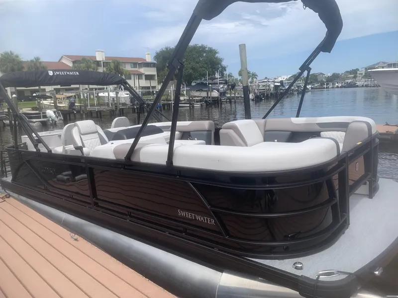 Slide: The Image of 2026 Godfrey Sweetwater 2286 FS pontoon boat docked at a marina. - 10