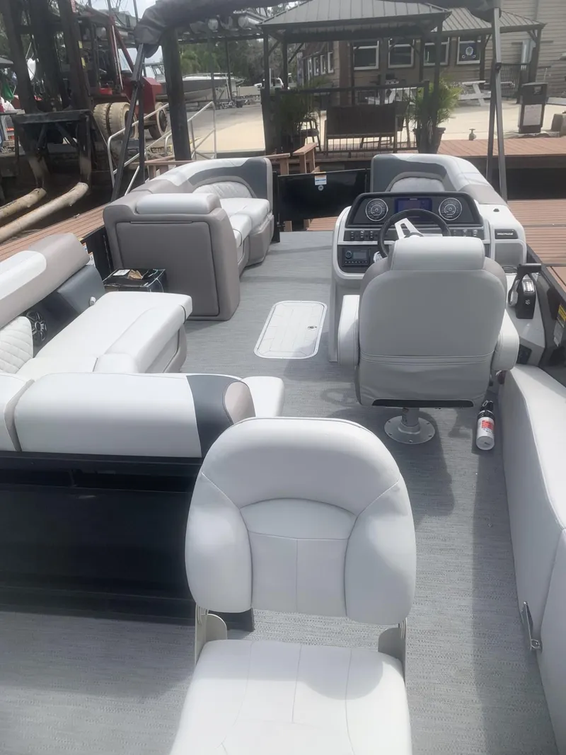 Slide: The Image of 2026 Godfrey Sweetwater 2286 FS pontoon boat interior with plush seating and modern dashboard. - 3